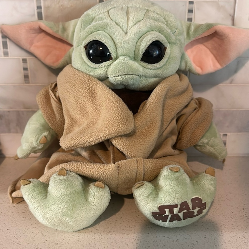 Build-a-Bear plush Grogu with Star Wars music included in hand.